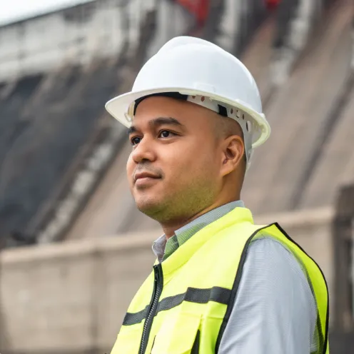 Asian man in high vis clothing and a hard hat